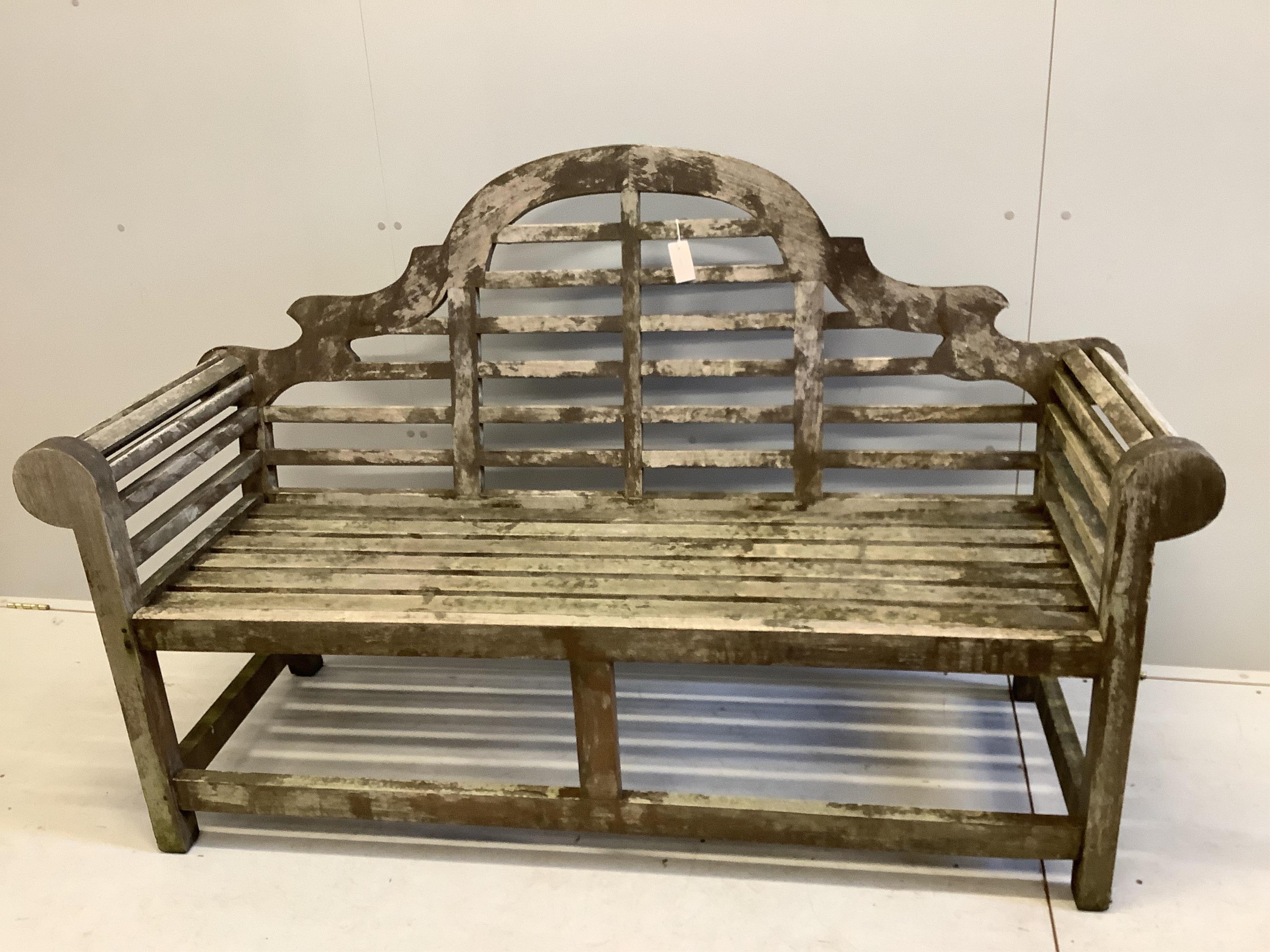 A Lutyens style weathered teak garden bench, width 165cm, depth 57cm, height 104cm. Condition - fair